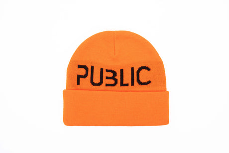 LogoCuffBeanie- A bright orange knit beanie with the word 'PUBLIC' embroidered in black across the front fold, shown on a plain white background.