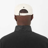 LogoFlatCap-Person wearing a white cap with a logo on a white background