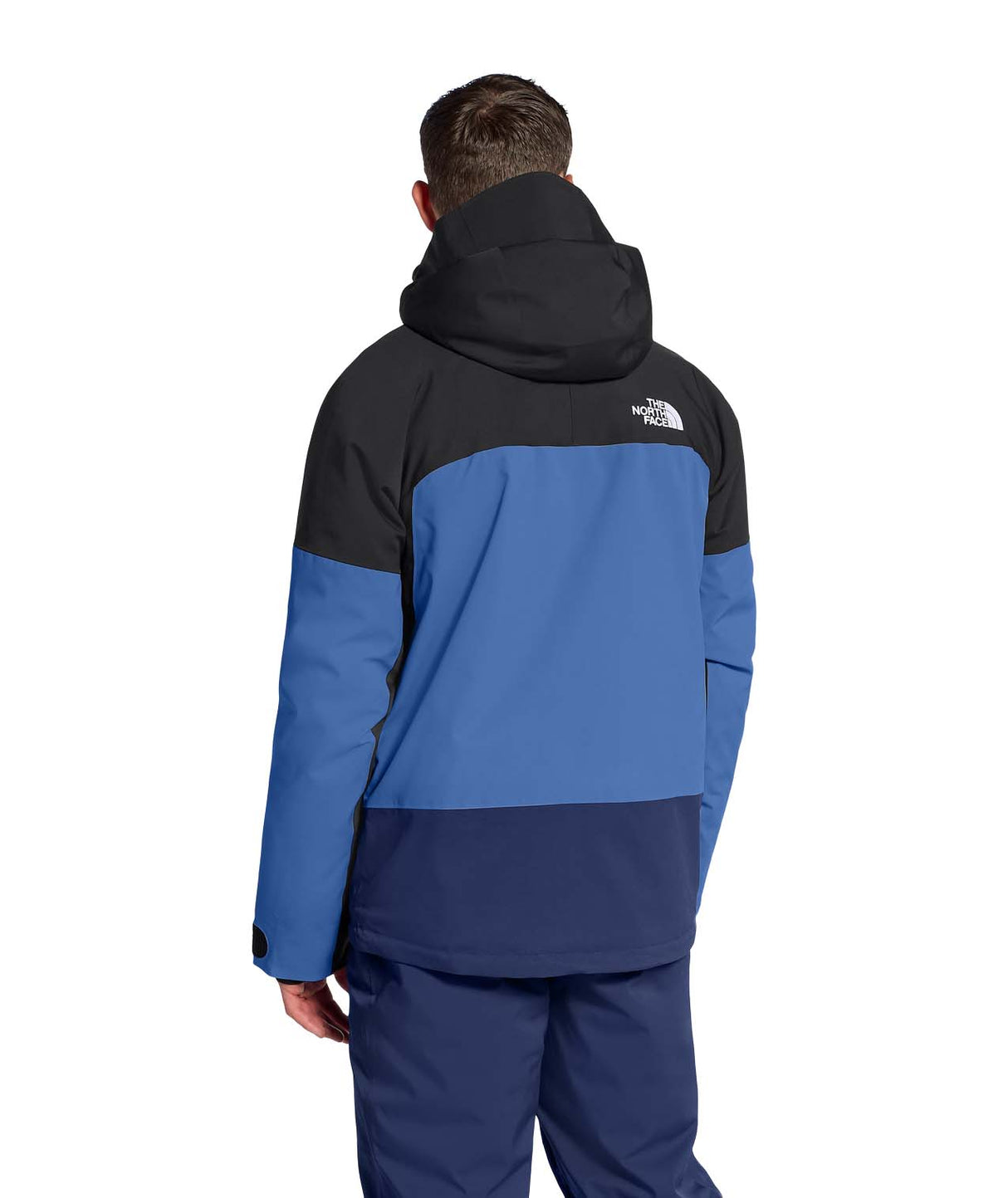 MChakalJacket-Person wearing a blue and black jacket with The North Face logo on a white background