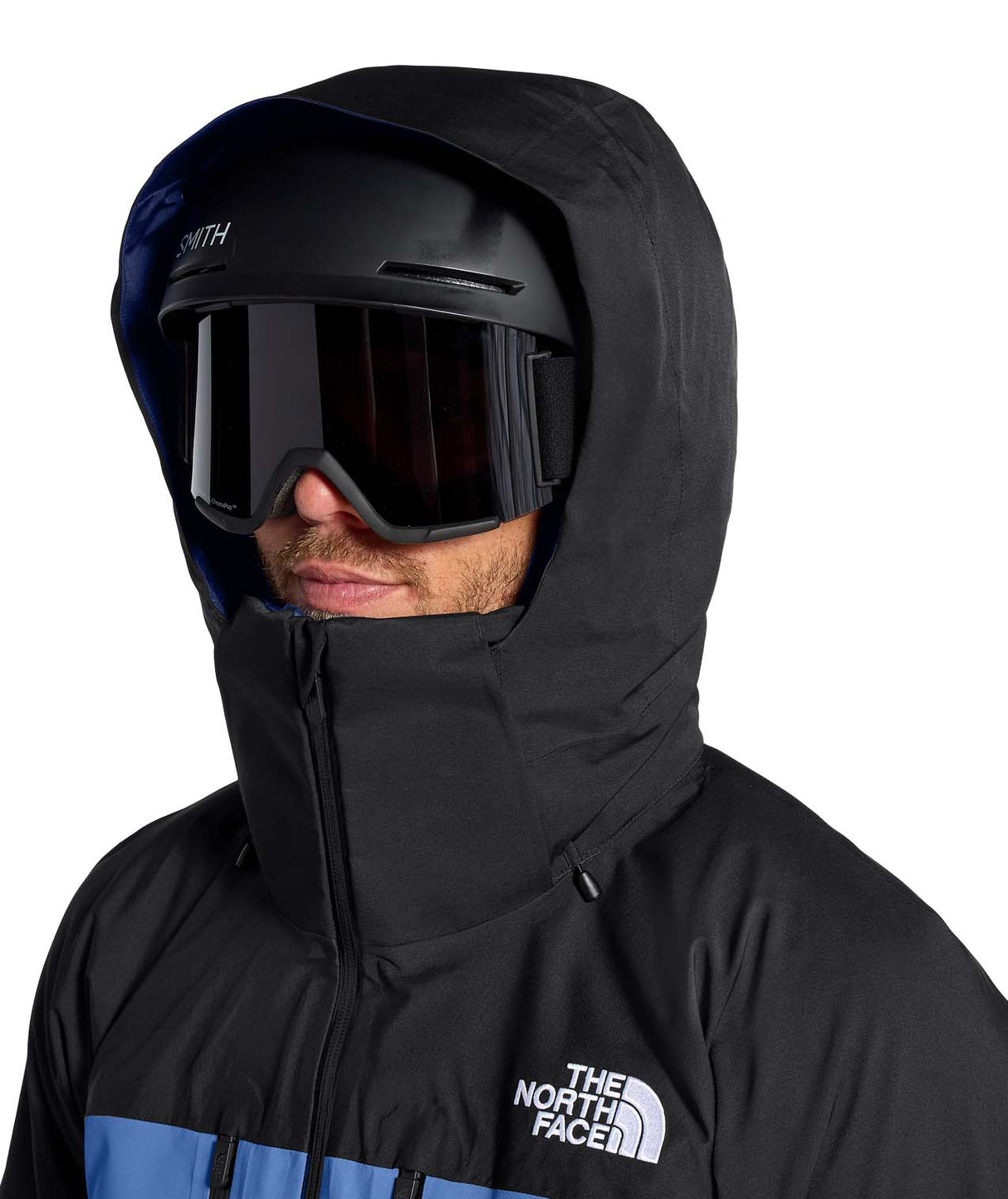 MChakalJacket-Person wearing a black hooded jacket with goggles and a helmet, featuring The North Face logo.