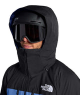MChakalJacket-Person wearing a black hooded jacket with goggles and a helmet, featuring The North Face logo.