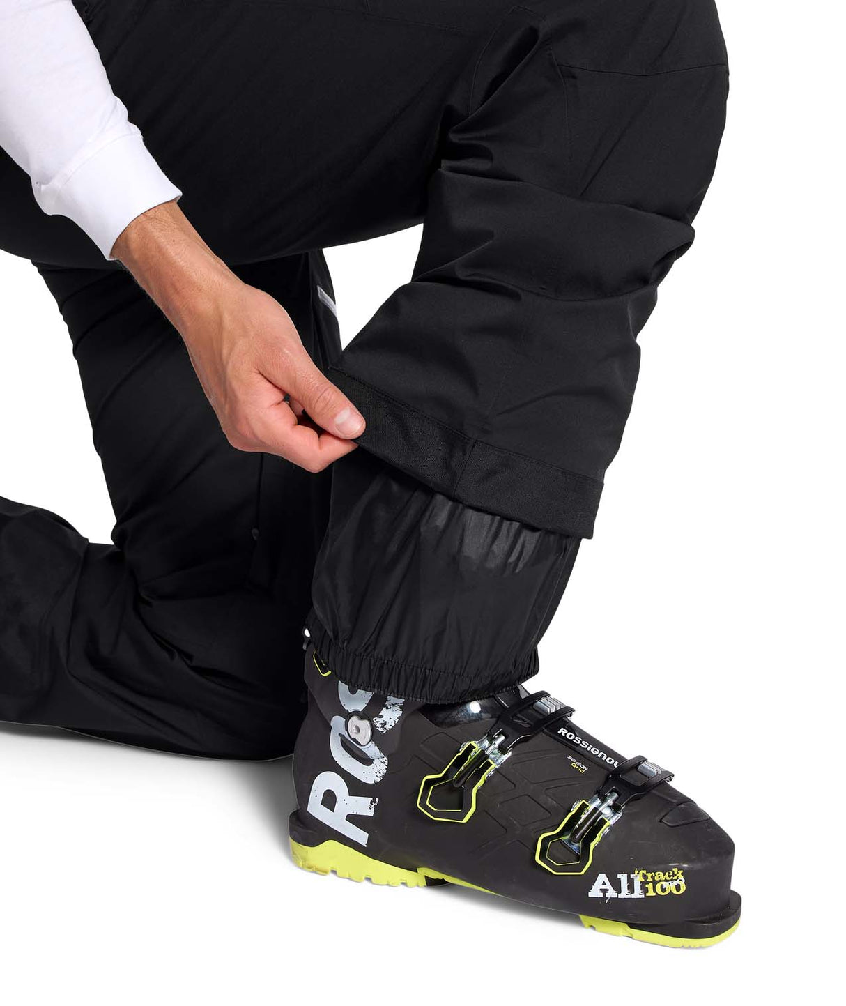 MChakalPant- Man wearing black snow pants with The North Face logo on a white background