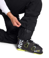 MChakalPant- Man wearing black snow pants with The North Face logo on a white background