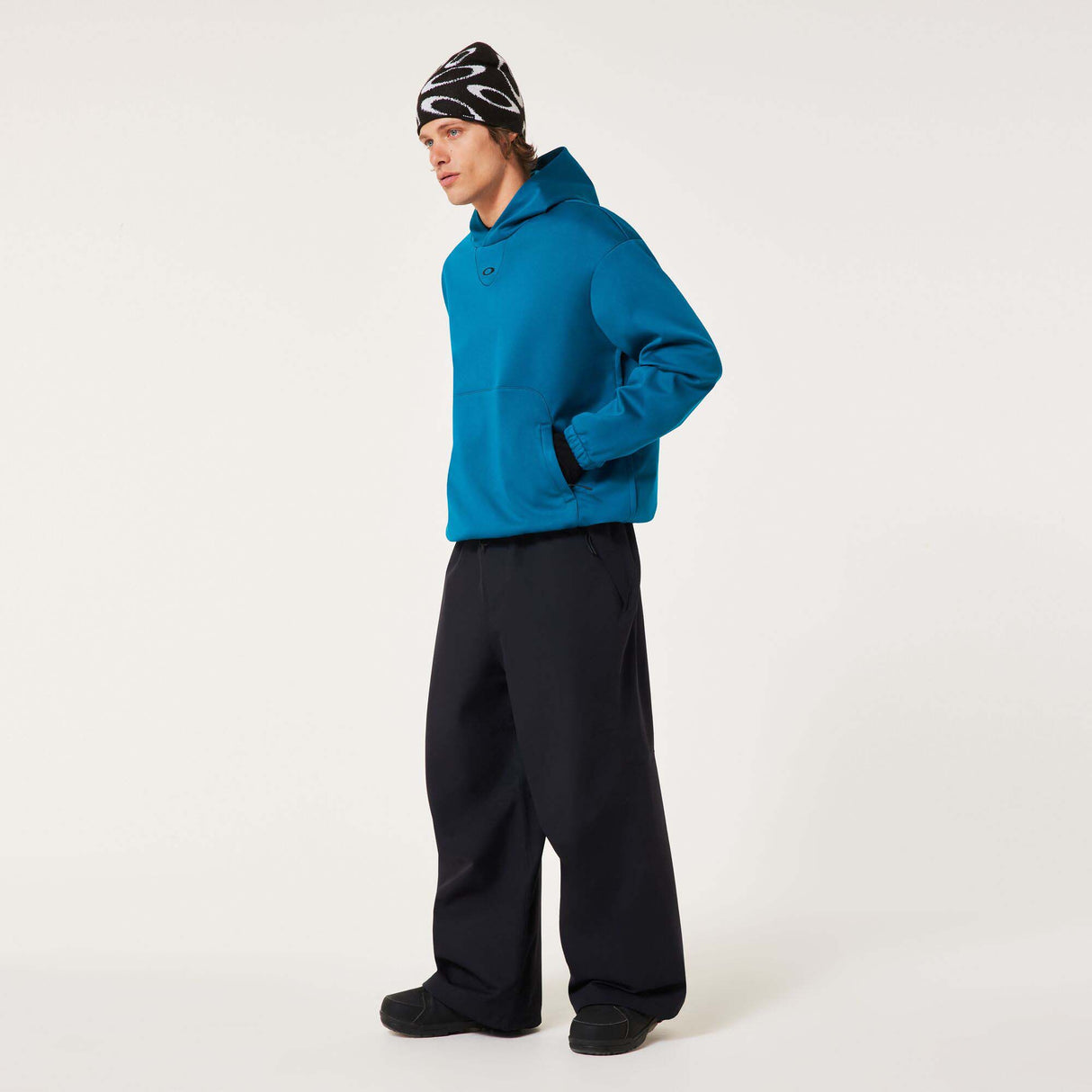 MChannelShellPant-Black wide-leg snow pants with an elastic drawstring waist and side pockets, shown on a light gray background.