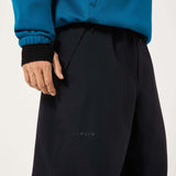 MChannelShellPant-Black wide-leg snow pants with an elastic drawstring waist and side pockets, shown on a light gray background.