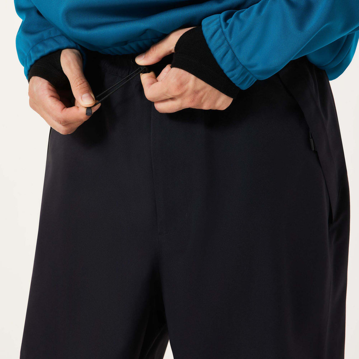 MChannelShellPant-Black wide-leg snow pants with an elastic drawstring waist and side pockets, shown on a light gray background.