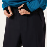 MChannelShellPant-Black wide-leg snow pants with an elastic drawstring waist and side pockets, shown on a light gray background.