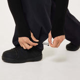 MChannelShellPant-Black wide-leg snow pants with an elastic drawstring waist and side pockets, shown on a light gray background.