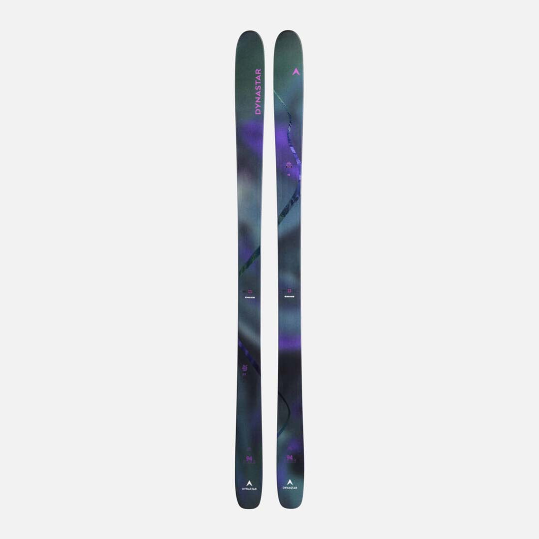 MFree94-A pair of Dynastar skis shown vertically against a light gray background, featuring a dark teal and purple marbled pattern with pink and white branding details.