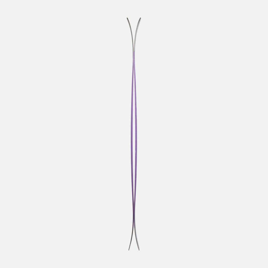 MFree94-A pair of Dynastar skis shown vertically against a light gray background, featuring a dark teal and purple marbled pattern with pink and white branding details.