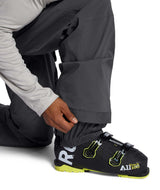 MFreedomBib- Man wearing grey bib overalls with The North Face logo on a white background