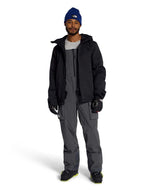 MFreedomBib- Man wearing grey bib overalls with The North Face logo on a white background