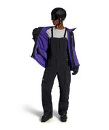 MFreedomBib-Person wearing a black snowsuit with a purple jacket on a white background