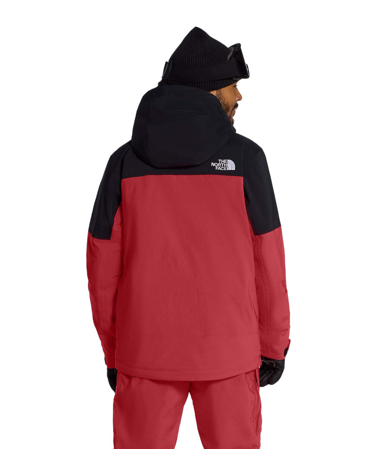 MFreedomInsulatedJacket- Person wearing a red and black jacket with a hood, standing against a white background.