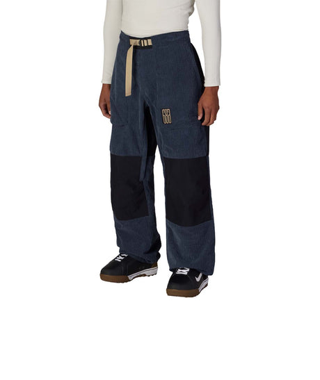 MGhost2.5LPant-Person wearing blue and black pants with beige accents on a white background