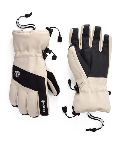 MGore-texLinearGlove- A pair of GORE-TEX winter gloves shown flat against a white background, displaying both the palm and back-of-hand views. The gloves feature a warm cream/beige fabric body with black panels on the back of the hand and wrist, black drawstrings, and a black GORE-TEX logo strip.