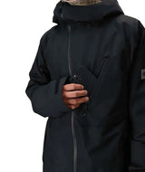 MHydraThermagraphJacket-A man wearing a black ski jacket with black zippers, black gloves, a cream neck gaiter, and a black beanie with goggles, photographed against a plain white background.