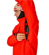 MHydraThermagraphJacket-A man wearing a bright red ski jacket with black zippers, black gloves, a black neck gaiter, and a red-and-black patterned bandana with goggles, photographed against a plain white background.