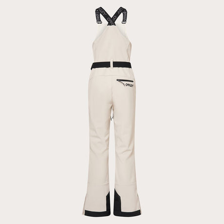 WTNPHarperSoftshellBib-White ski jumpsuit with a belt on a light gray background