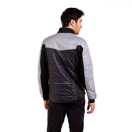 MMayenQuiltedJacket- A man wearing a gray and black color-blocked puffer jacket with black pants, standing against a solid white background.