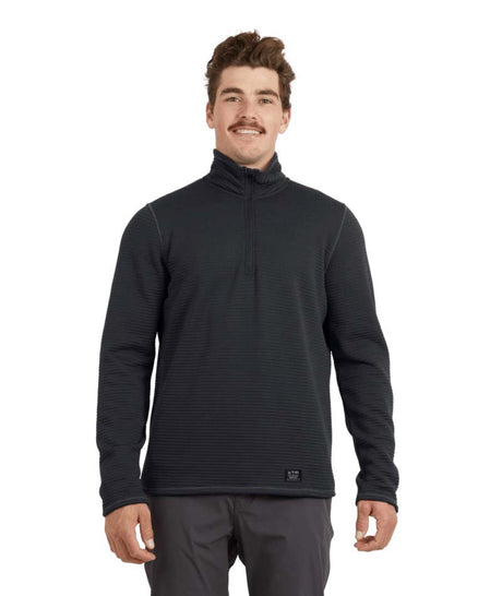 MMerinoAeroGridFleece-A man wearing a dark charcoal gray quarter-zip long-sleeve performance pullover and dark gray pants, standing against a solid white background.