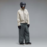 MMthodGlowShellJacket-A light beige technical jacket with black zippers, black piping details, and an Oakley logo on the left chest, displayed against a neutral gray background.