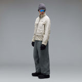 MMthodGlowShellJacket-A light beige technical jacket with black zippers, black piping details, and an Oakley logo on the left chest, displayed against a neutral gray background.