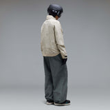 MMthodGlowShellJacket-A light beige technical jacket with black zippers, black piping details, and an Oakley logo on the left chest, displayed against a neutral gray background.