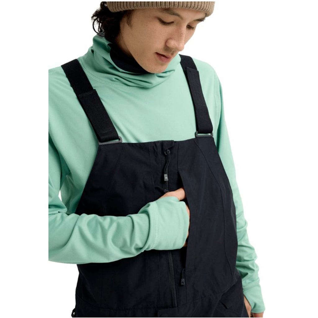 MReserveGORE-TEX2LBib-Person wearing a green shirt and black overalls on a white background
