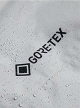 MReserveGORE-TEX2LInsulatedJacket-Light gray jacket with black zippers on a white background