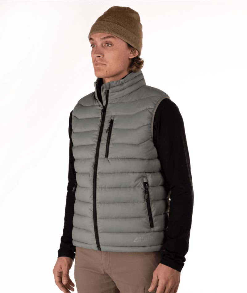 MSawyerPuffyVest-Man wearing a grey puffer vest over a black shirt on a white background