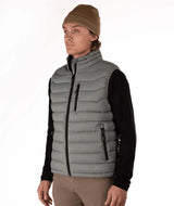 MSawyerPuffyVest-Man wearing a grey puffer vest over a black shirt on a white background