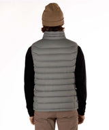 MSawyerPuffyVest-Man wearing a grey puffer vest over a black shirt on a white background