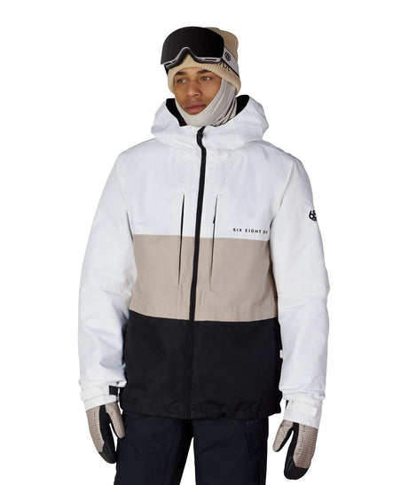 MSmarty3-in-1FormJacket-Person wearing a white and beige ski jacket with black pants on a white background