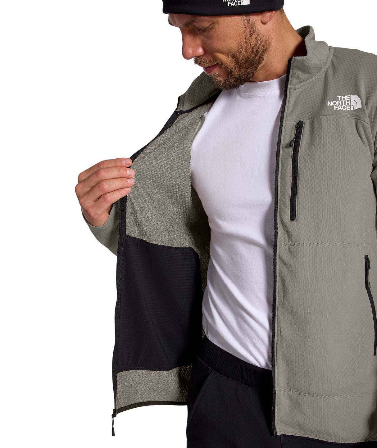 MSummitFUTUREFLEECEFullZipJacket-Man wearing a gray jacket with The North Face logo, white shirt, and black pants on a white background