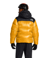 MSummitNuptseJacket-Yellow and black puffer jacket with The North Face logo on a white background