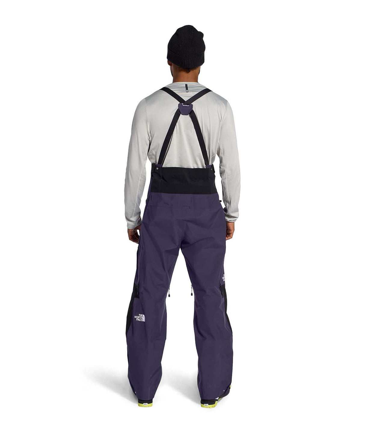 MSummitVerbierGTXBib-Man wearing a black and purple bib overalls on a white background