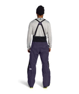 MSummitVerbierGTXBib-Man wearing a black and purple bib overalls on a white background