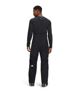 MSummitVerbierGTXBib-Person wearing a black outfit with a brand logo on a white background