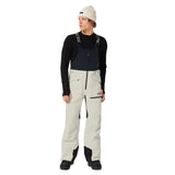 MTNPShellBib-Person wearing a black long-sleeve shirt, light gray pants, and a white beanie on a white background