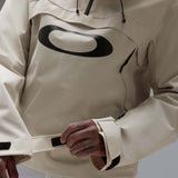 MTimberlineShellAnorak-An off-white hooded anorak jacket with a large black Oakley logo on the chest, displayed against a neutral gray gradient background.