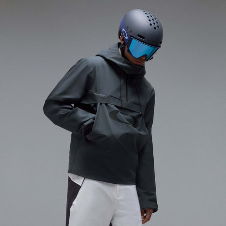 MTimberlineShellAnorak-A dark gray hooded jacket with a large tonal Oakley logo on the chest, displayed against a neutral gray background.