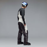 MTimberlineShellBib-A white and black technical snow bib with adjustable shoulder straps, a front zipper, and reinforced lower leg panels, shown against a neutral gray gradient background.