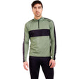 MTista1_2ZipMidlayer- A man wearing a sage green and black long-sleeve quarter-zip athletic pullover, paired with black pants, against a plain white background.