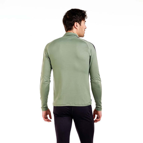 MTista1_2ZipMidlayer- A man wearing a sage green and black long-sleeve quarter-zip athletic pullover, paired with black pants, against a plain white background.