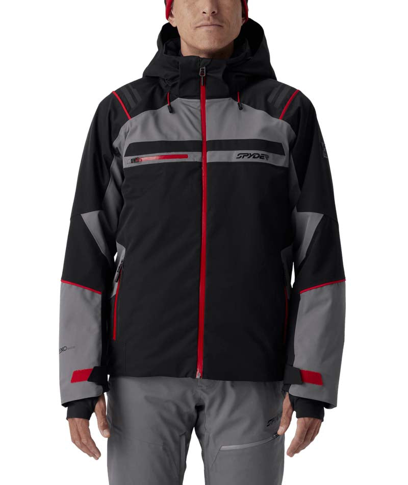 MTitanJacket- Man wearing a black, red, and grey ski jacket on a white background