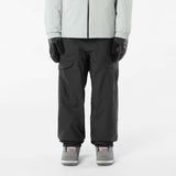MVenomShellPant-Person wearing a light gray jacket and black pants on a white background