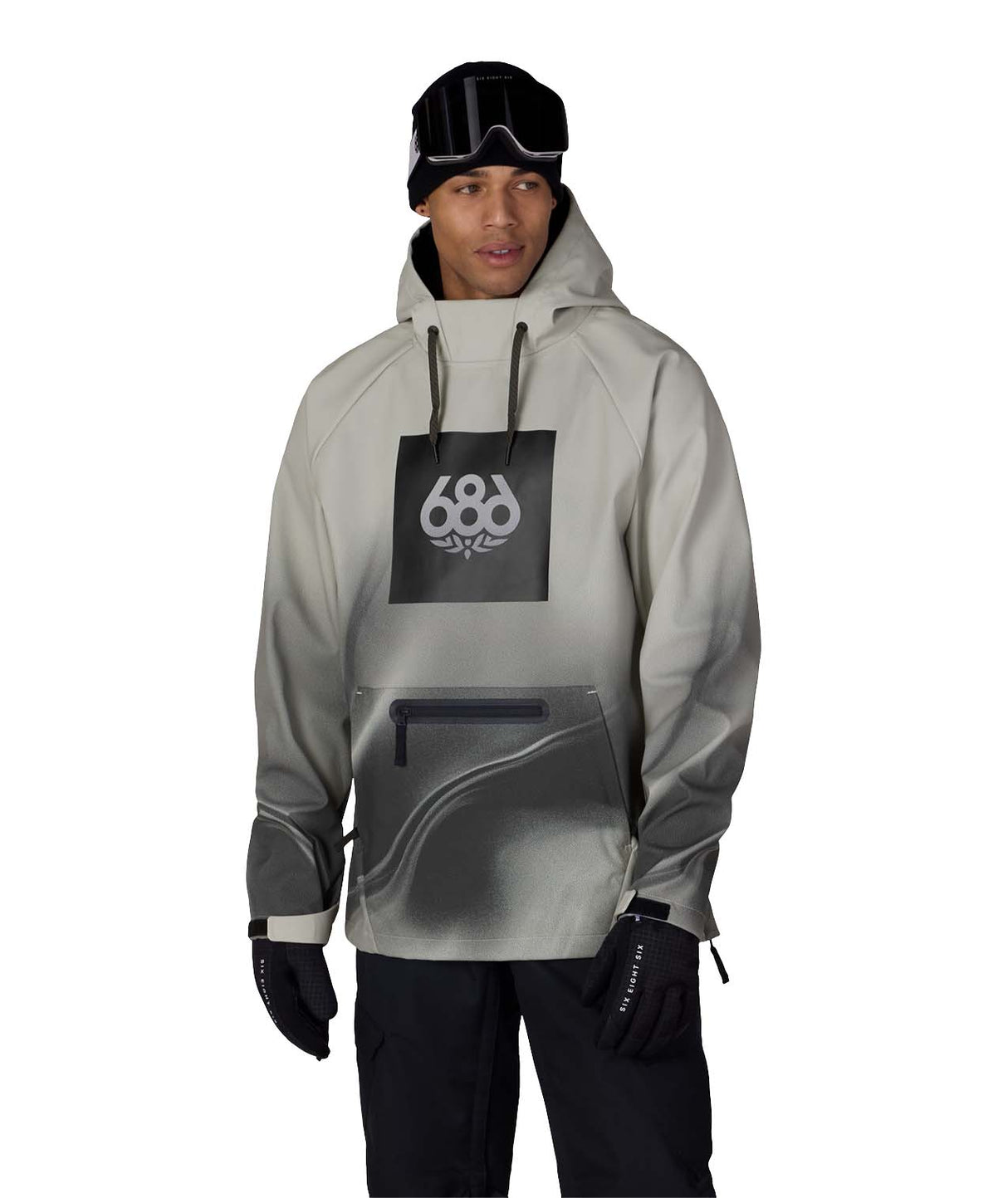 MWaterproofHoody-A man modeling a light gray and black 686 hooded snow jacket with a black chest logo, black pants, black gloves, and a black beanie with goggles, set against a plain white background.