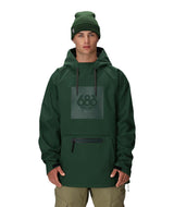 MWaterproofHoody-A man wearing a dark green hooded snowboard jacket with a tonal green 688 logo on the chest, paired with a matching green beanie and khaki pants, against a plain white background.