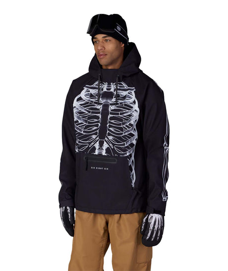MWaterproofHoody-A man wearing a black hooded jacket with a large white skeleton ribcage graphic on the front, black gloves, and tan pants, photographed against a plain white studio background.